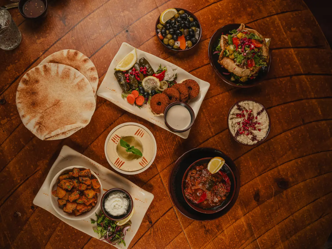 Overhead mezze spread with pita bread, falafel, hummus and dips at Beirut Restaurant, food photography session by Gorka Di Capitan (gorkadicapitan.com)