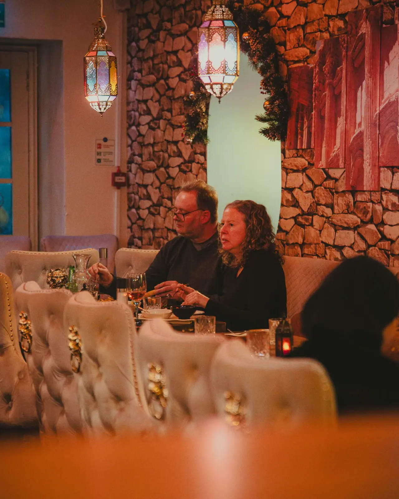 Guests dining under Christmas garlands and Lebanese lanterns at Beirut Restaurant